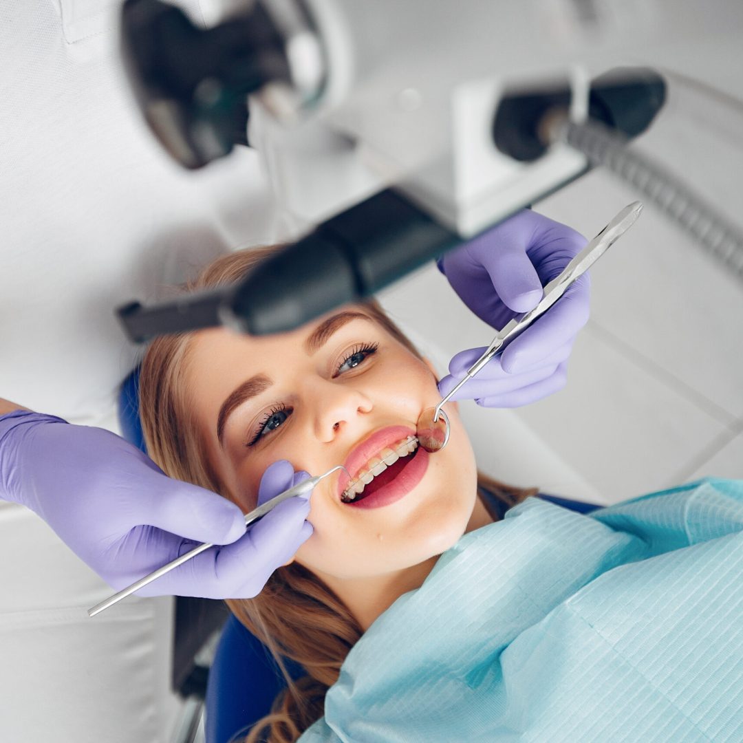 Beautiful lady in the dentist's office. Woman in a uniform