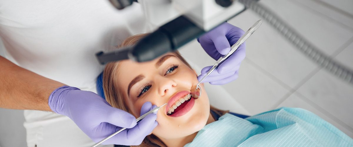 Beautiful lady in the dentist's office. Woman in a uniform