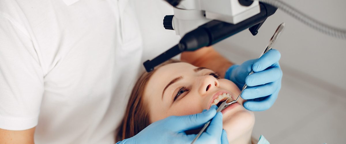 Beautiful lady in the dentist's office. Woman in a uniform